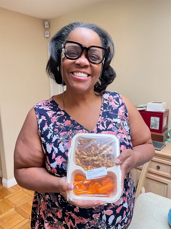 yolanda-smiling-with-meal