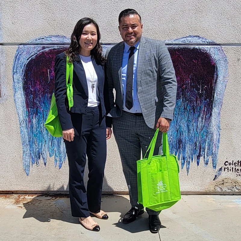 woman-and-man-standing-in-front-of-angel-wings-mural