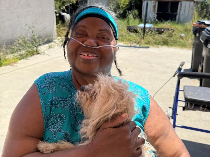 St. Vincent Meals on Wheels client outisde with her dog